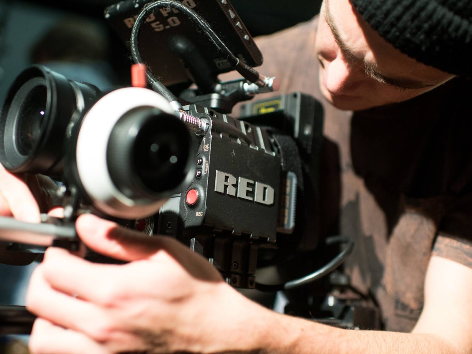 Student adjusting a film camera for a class