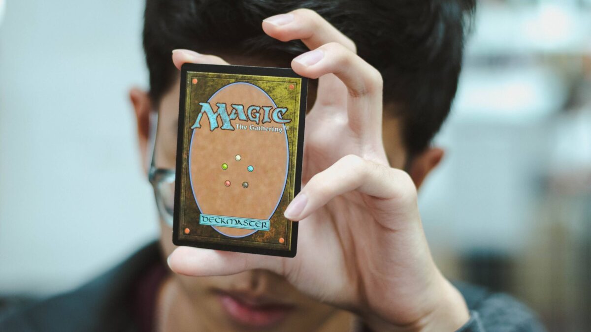 A student holding up a Magic the Gathering card