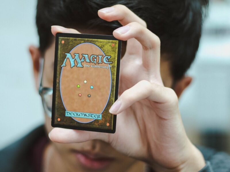 A student holding up a Magic the Gathering card