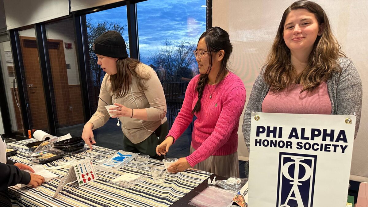 Students tabling their Phi Alpha club during a campus event