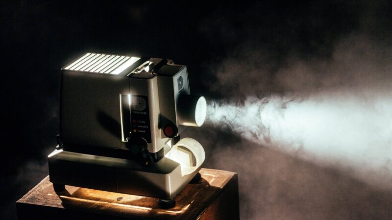 Projector showing a film in a dark and smoky room