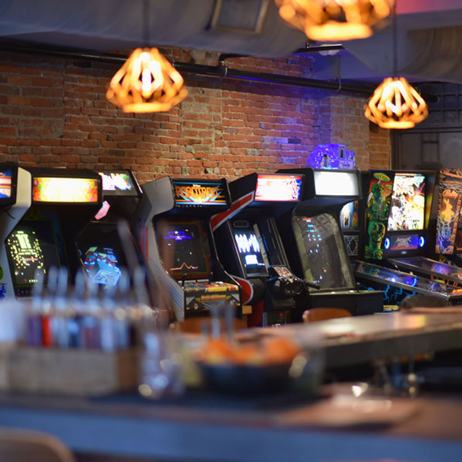 Video game machines line a wall at an arcade bar in Burlington, Vermont.