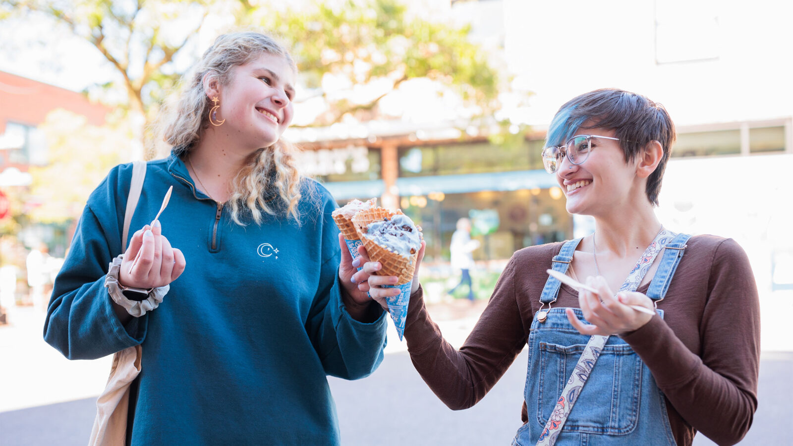two students enjoying ice cream from ben and jerry's and smiling