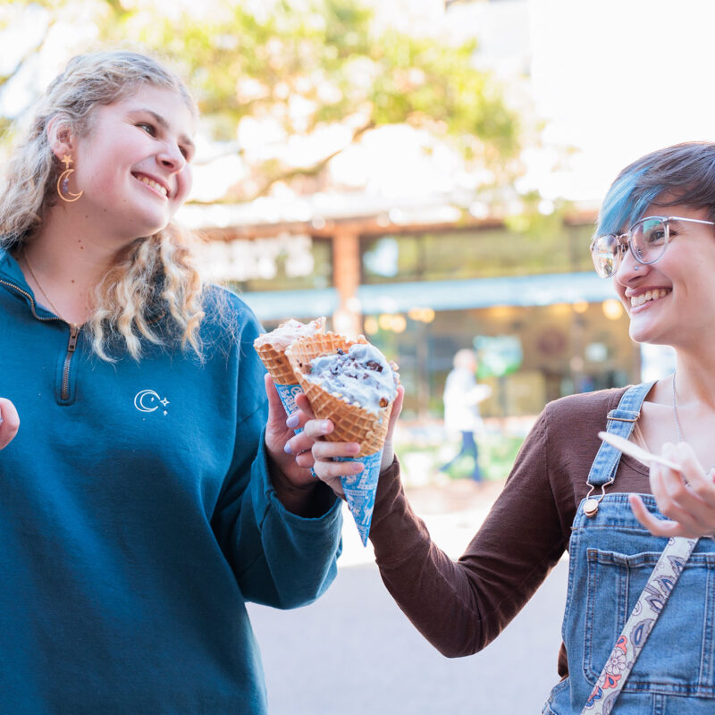 two students enjoying ice cream from ben and jerry's and smiling