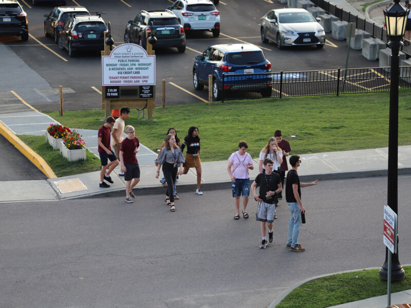 students walking away from a parking lot in downtown burlington