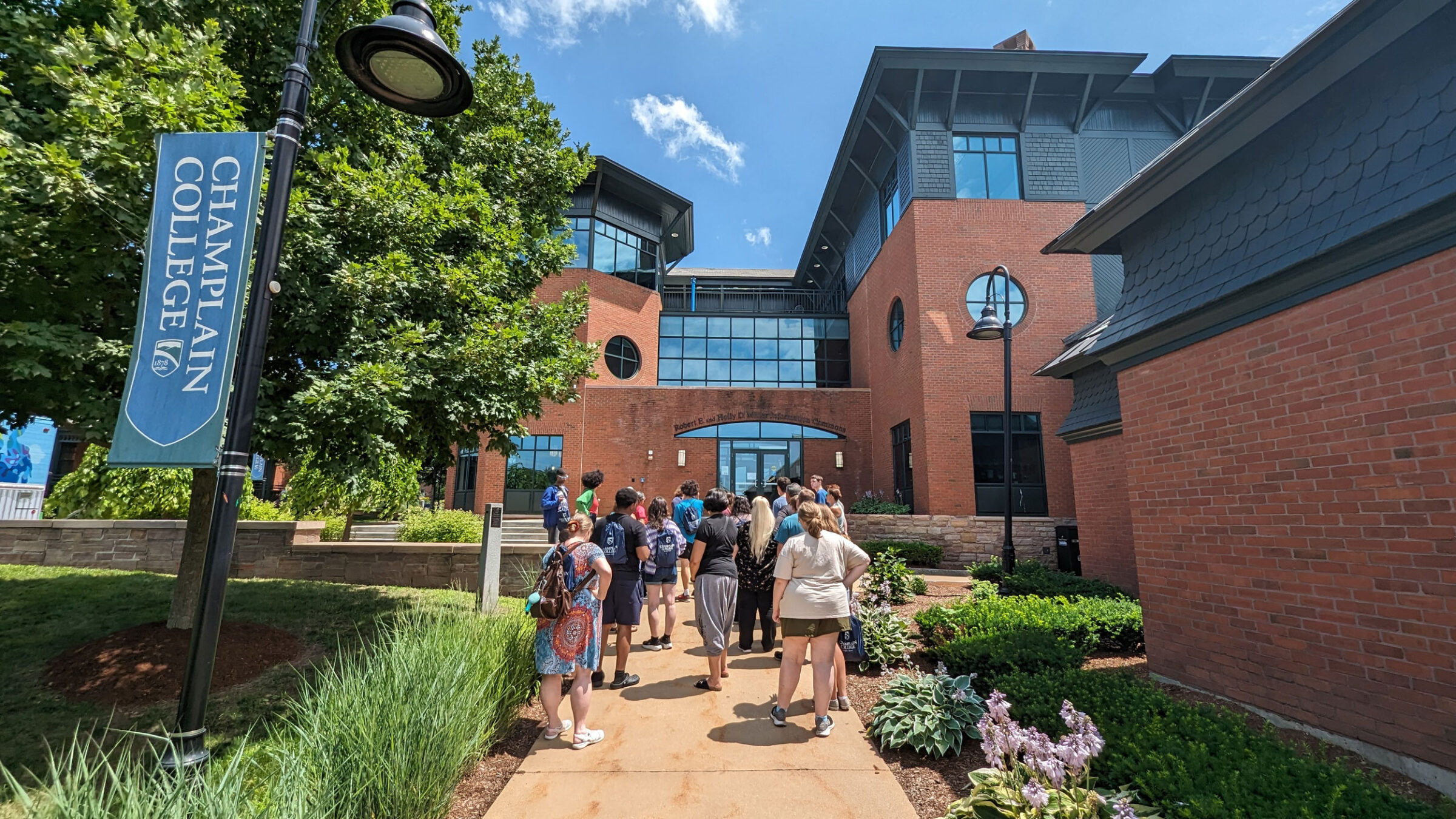 A tour group at Champlain College walks toward the library
