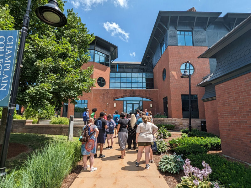 A tour group at Champlain College walks toward the library