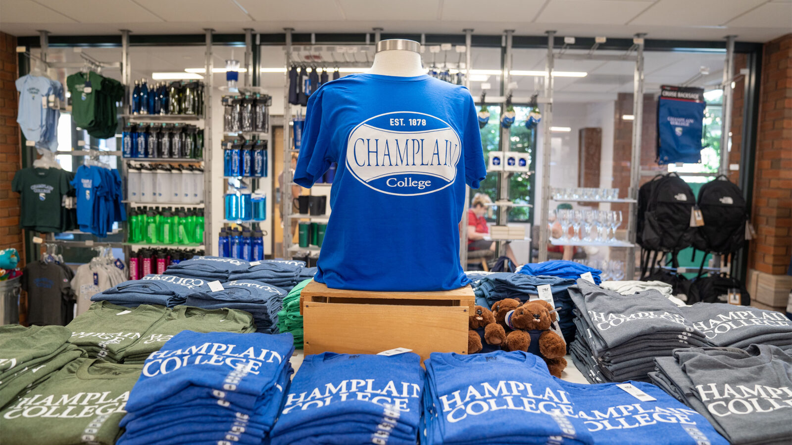 a display table full of Champlain College t-shirts in the campus store
