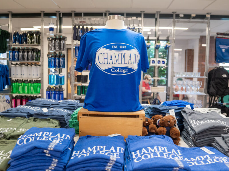 a display table full of Champlain College t-shirts in the campus store