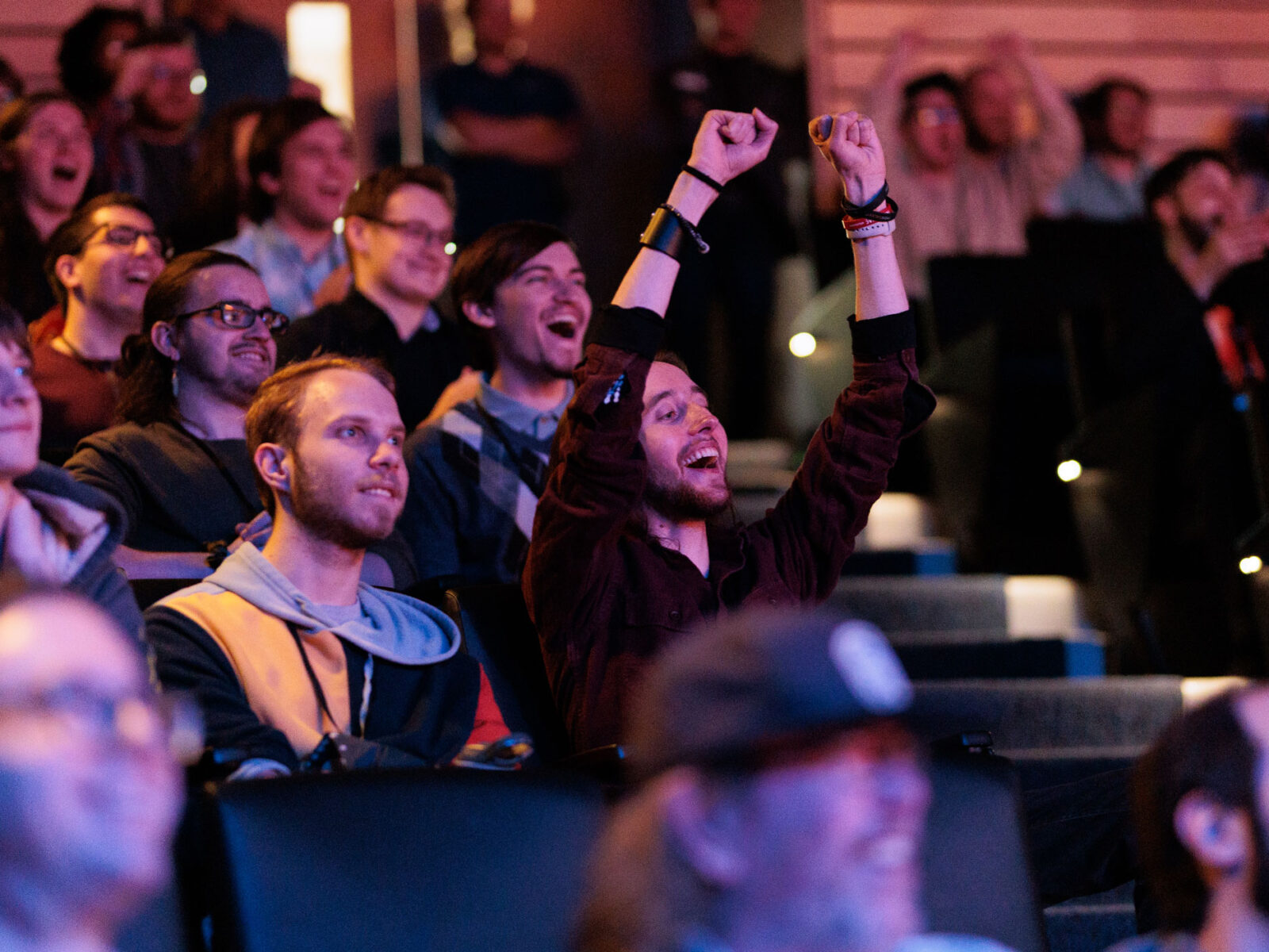 Crowd cheers for students presenting at the Senior Show.