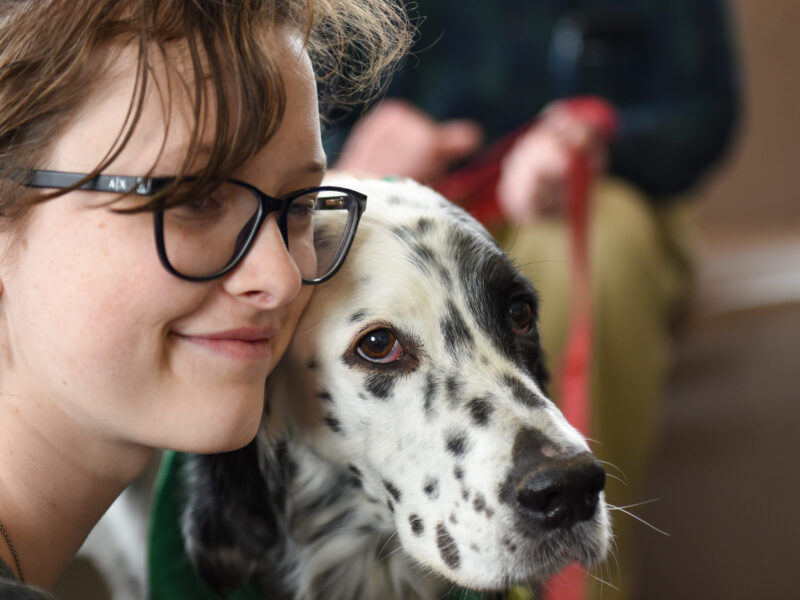 student enjoys times with a therapy dog