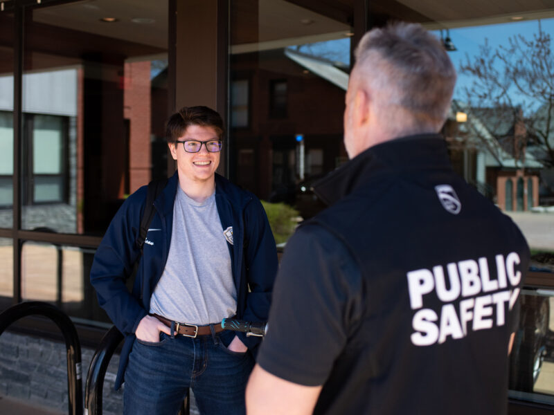 student talks casually to campus safety officer