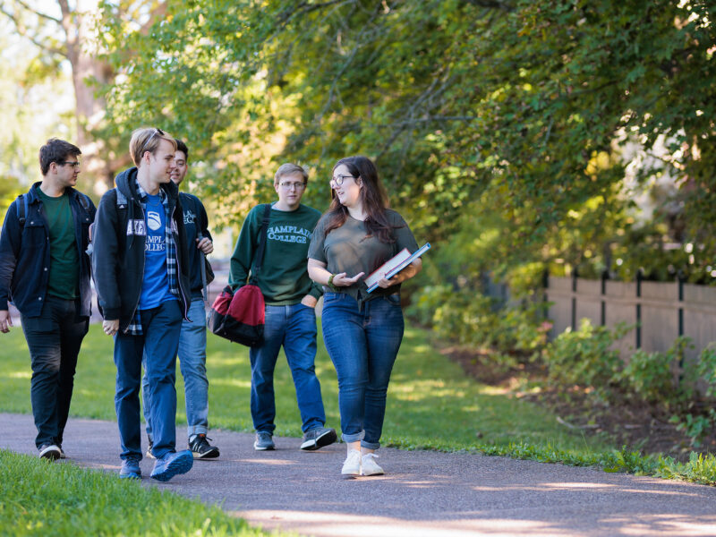 students walking along sidewalk to class
