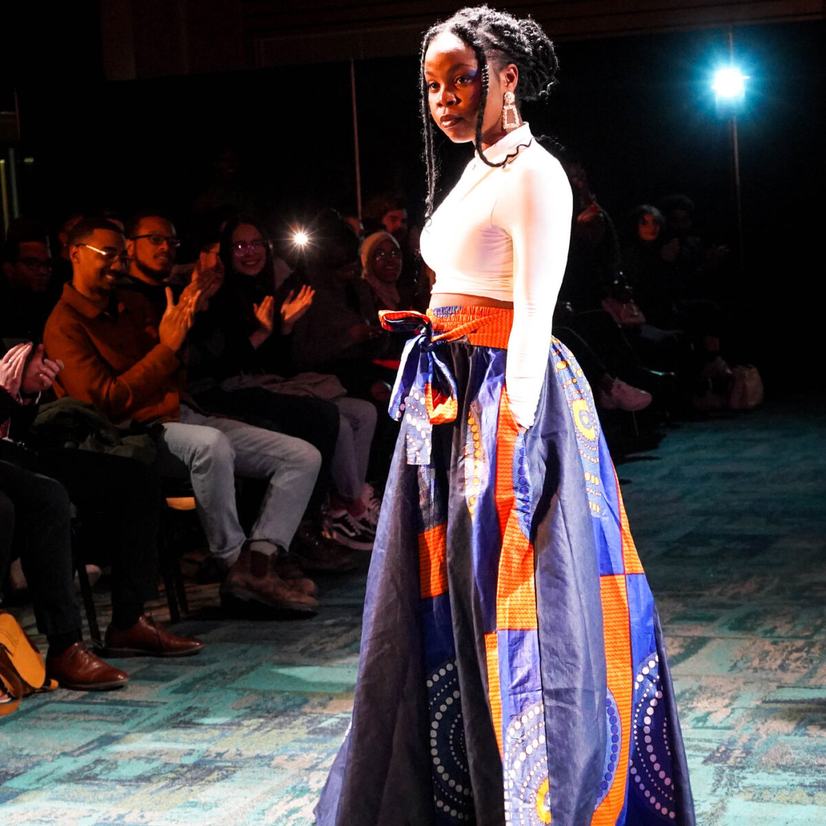 student in colorful ethnic gown at fashion show