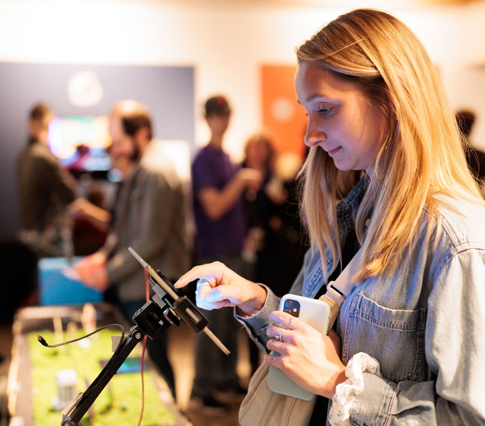 a student tests out a mobile game on a tablet at the senior game show
