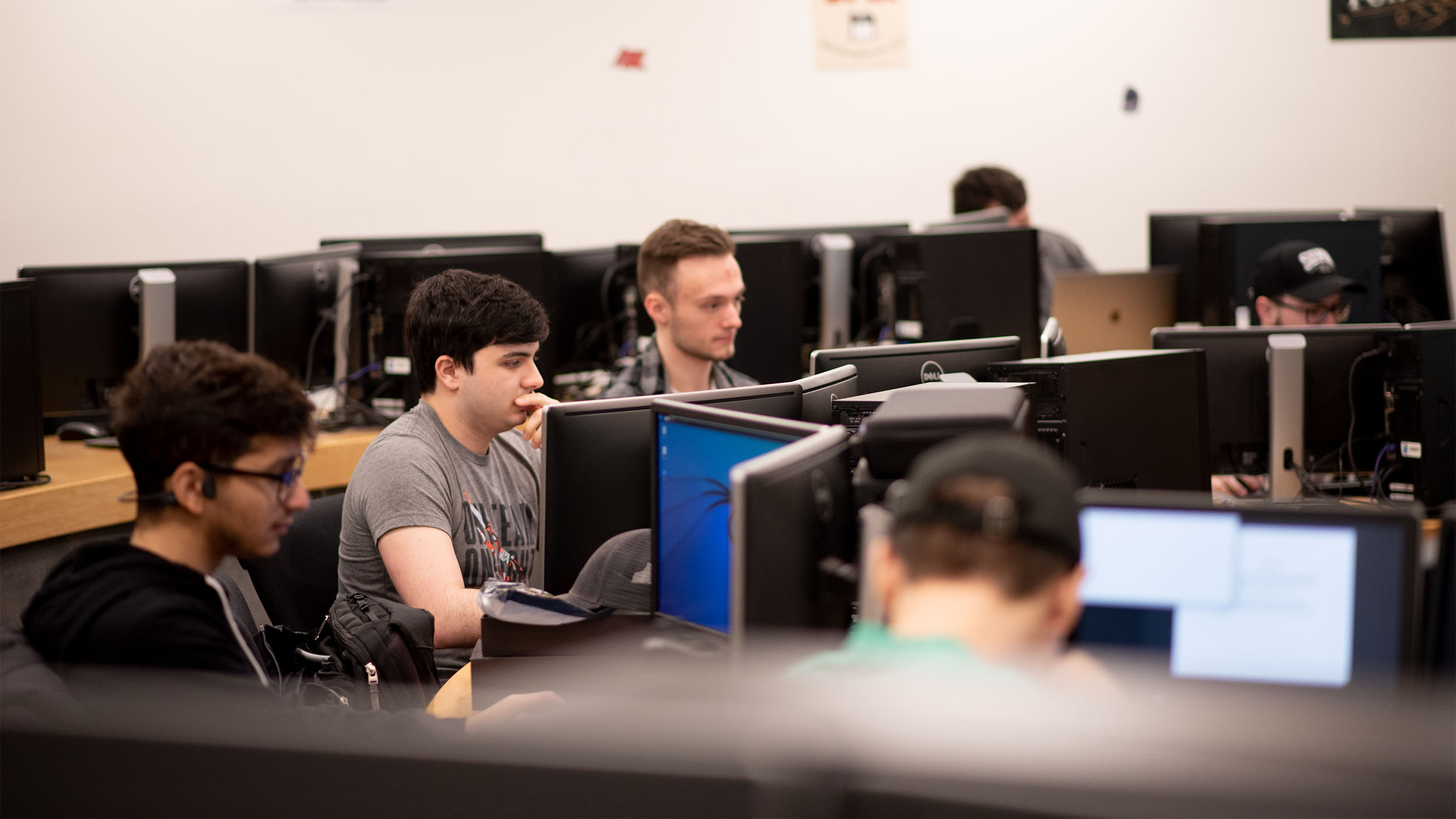 male cybersecurity students all working on computers
