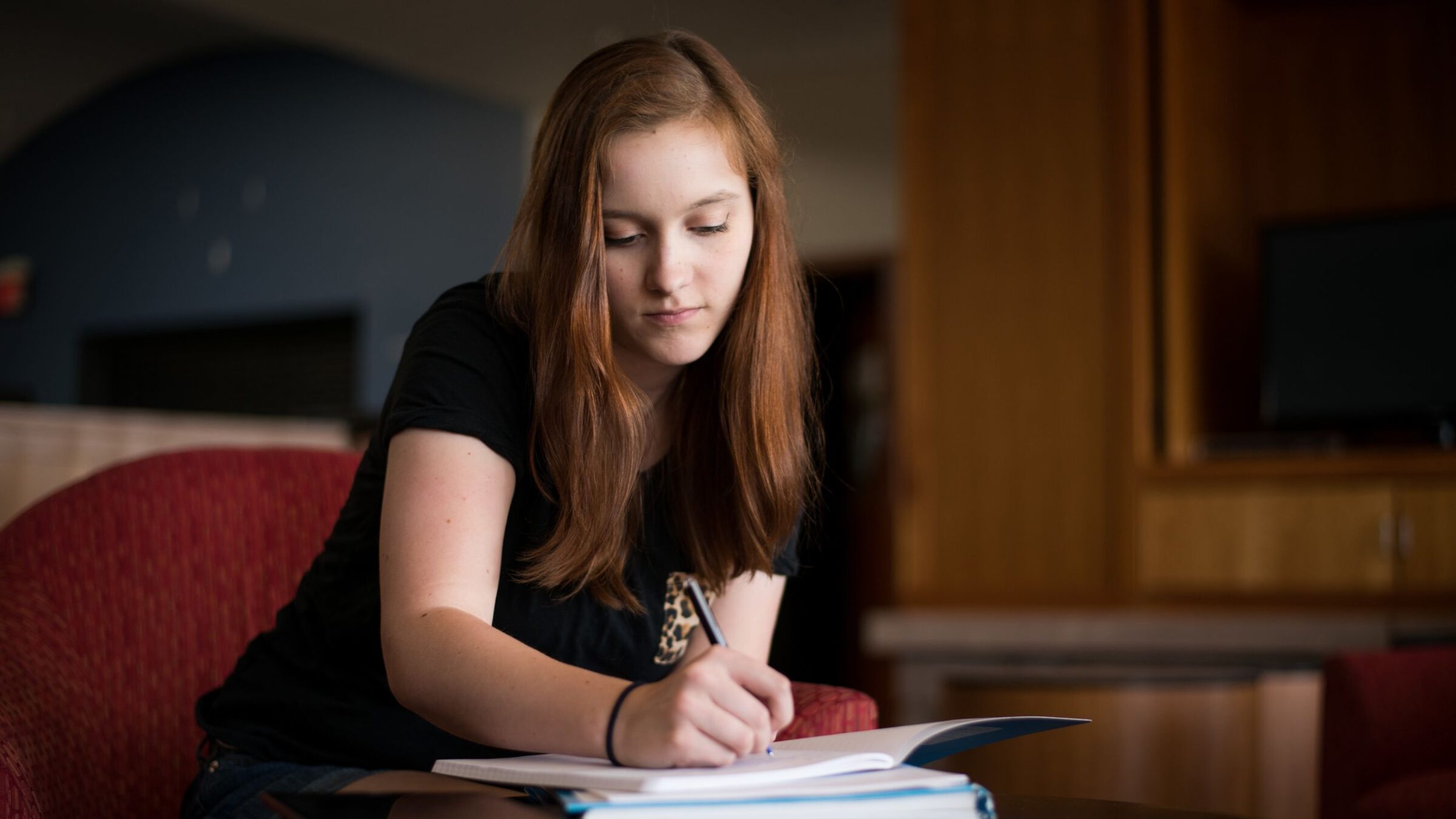 student working in fireside with a serious expression