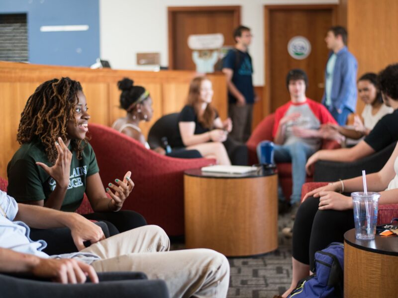 students talking in fireside lounge