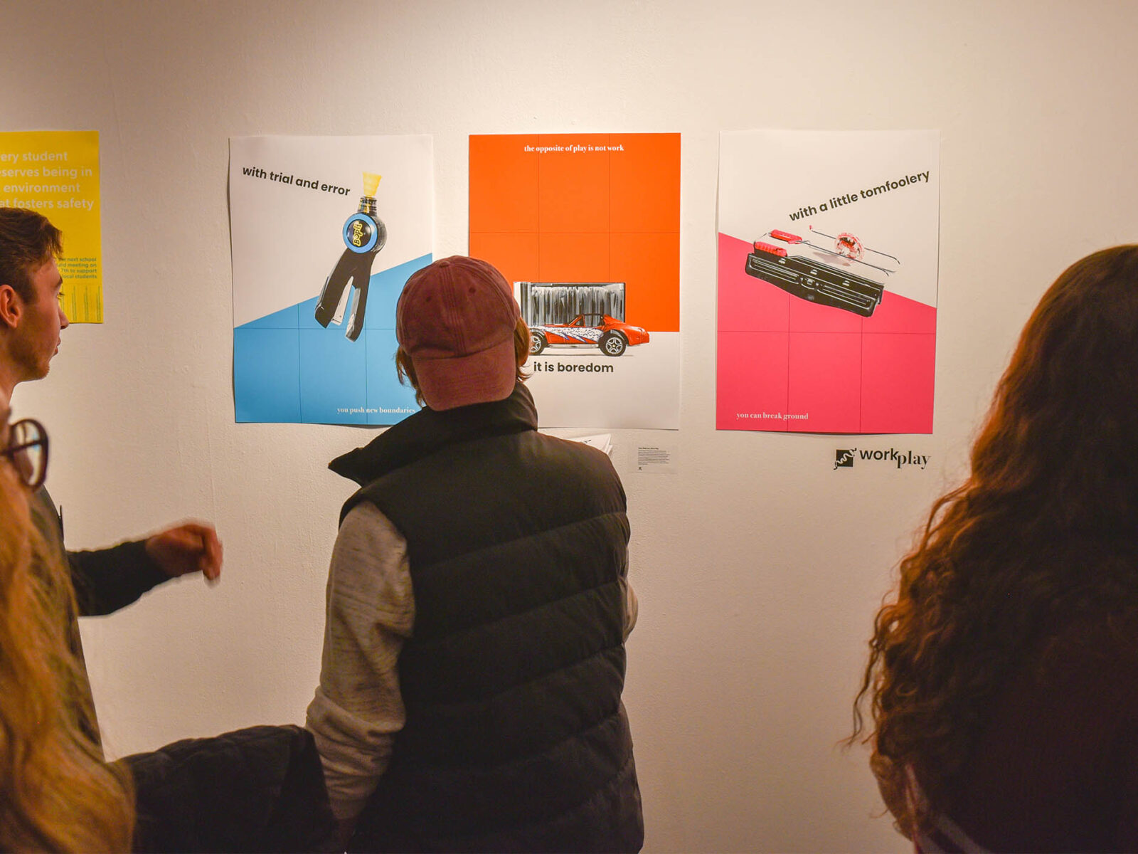 students looking at work at a graphic design exhibition