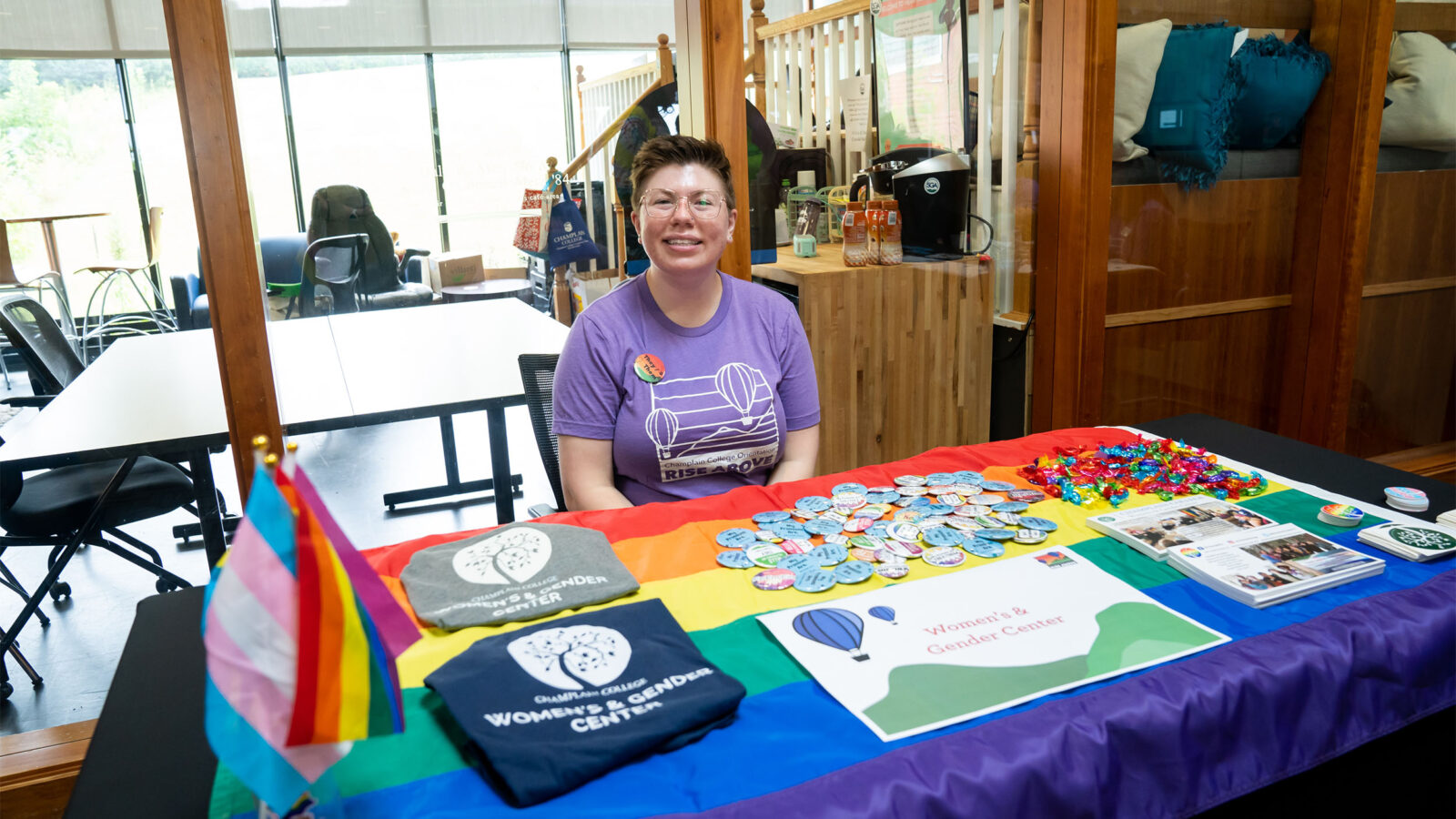 women's and gender center booth table set up featuring pride flags