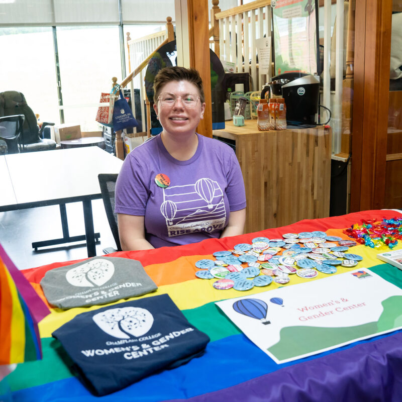 women's and gender center booth table set up featuring pride flags