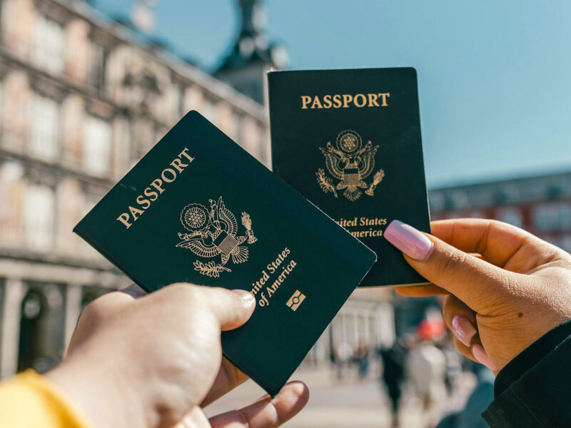 US passport held up in front of foreign building