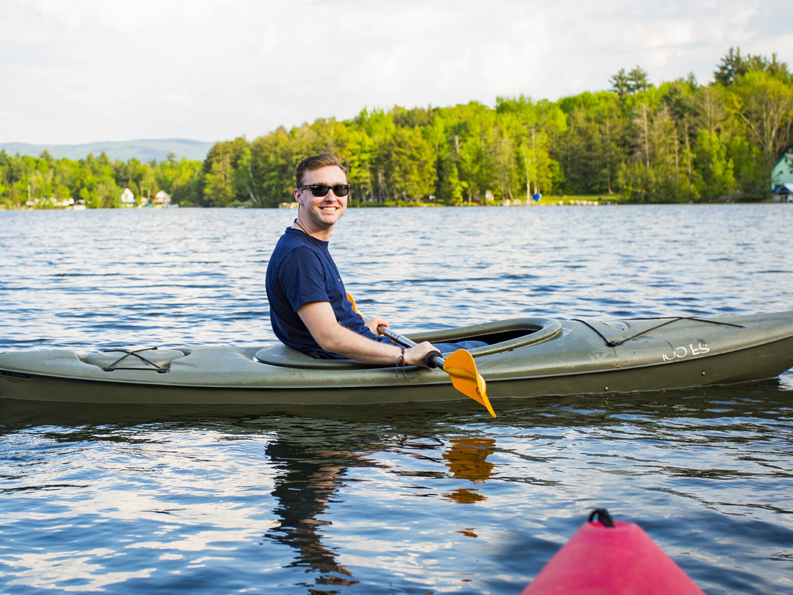 man sitting in a kayak on the lake