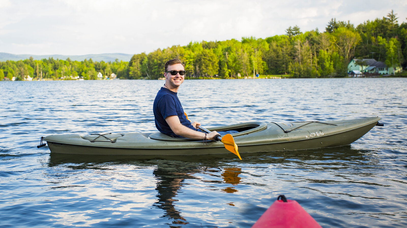 man sitting in a kayak on the lake