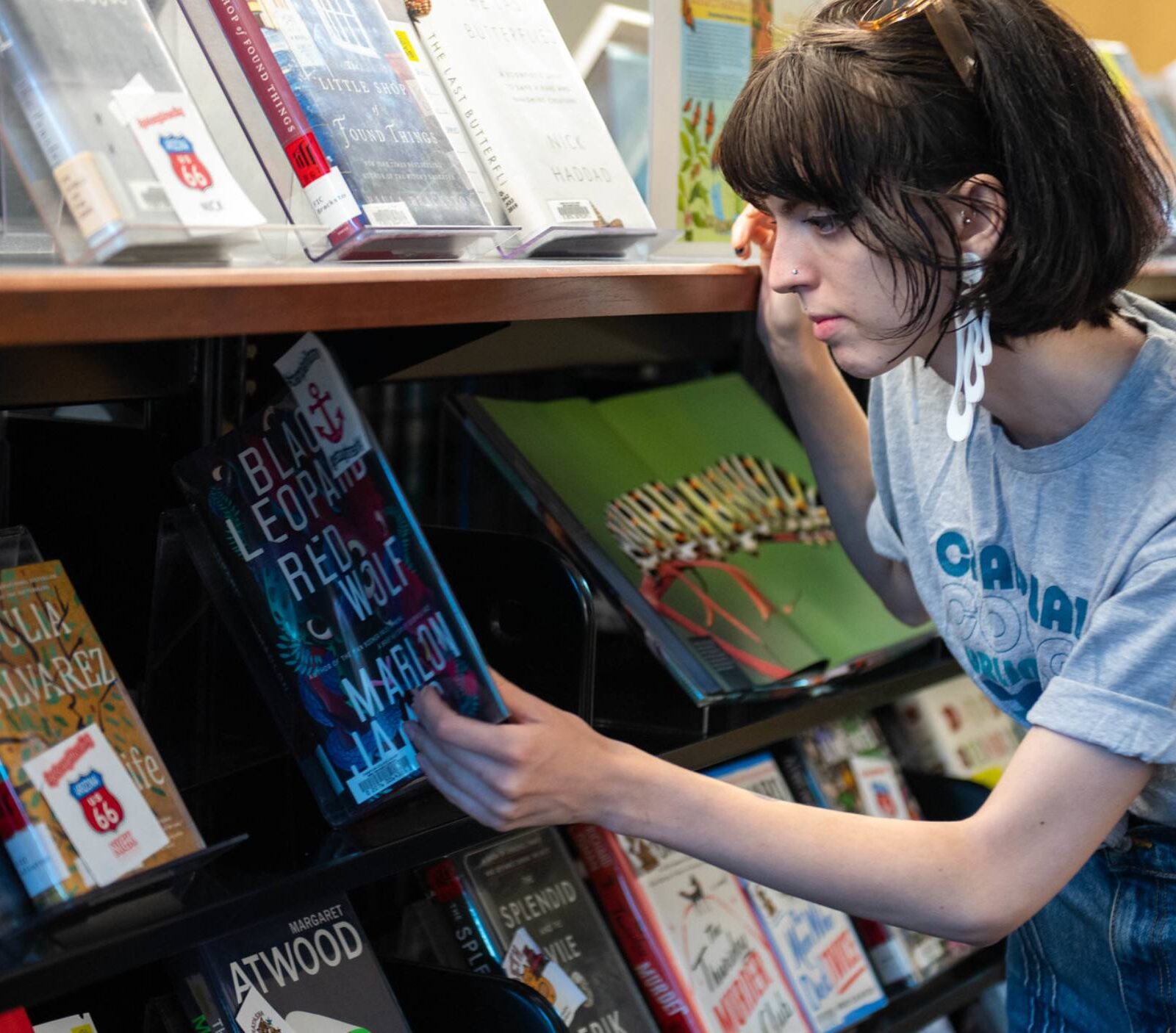a student browsing the fiction books in the library