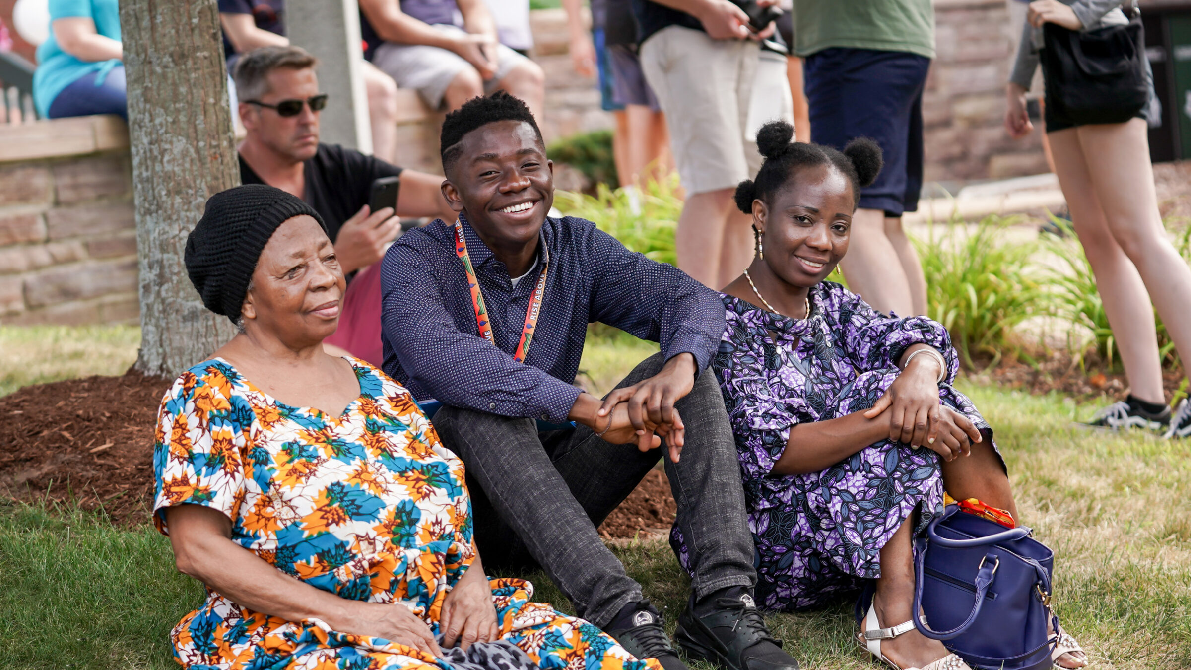 family sits on the lawn at orientation