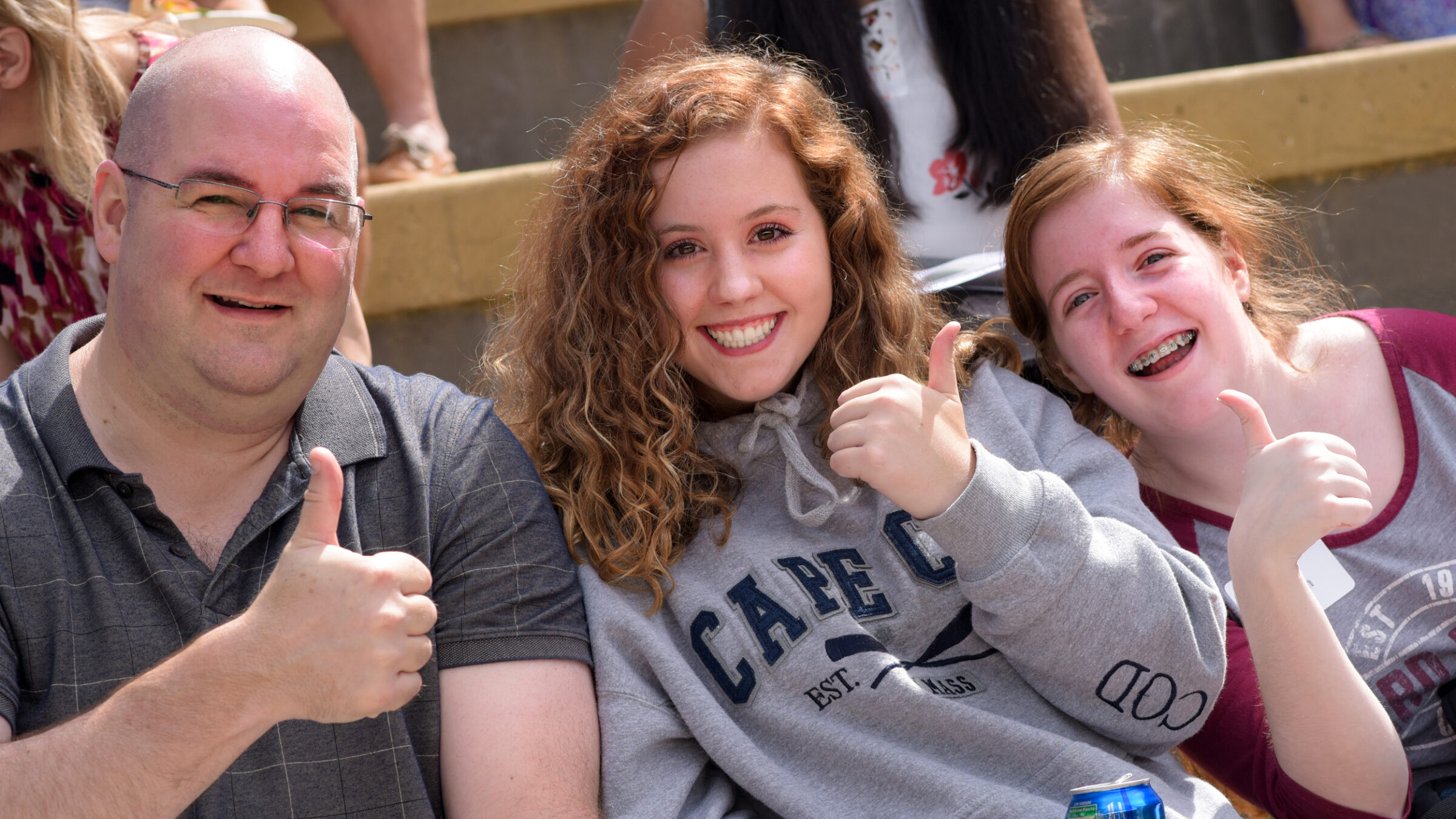 family giving the thumbs up sign