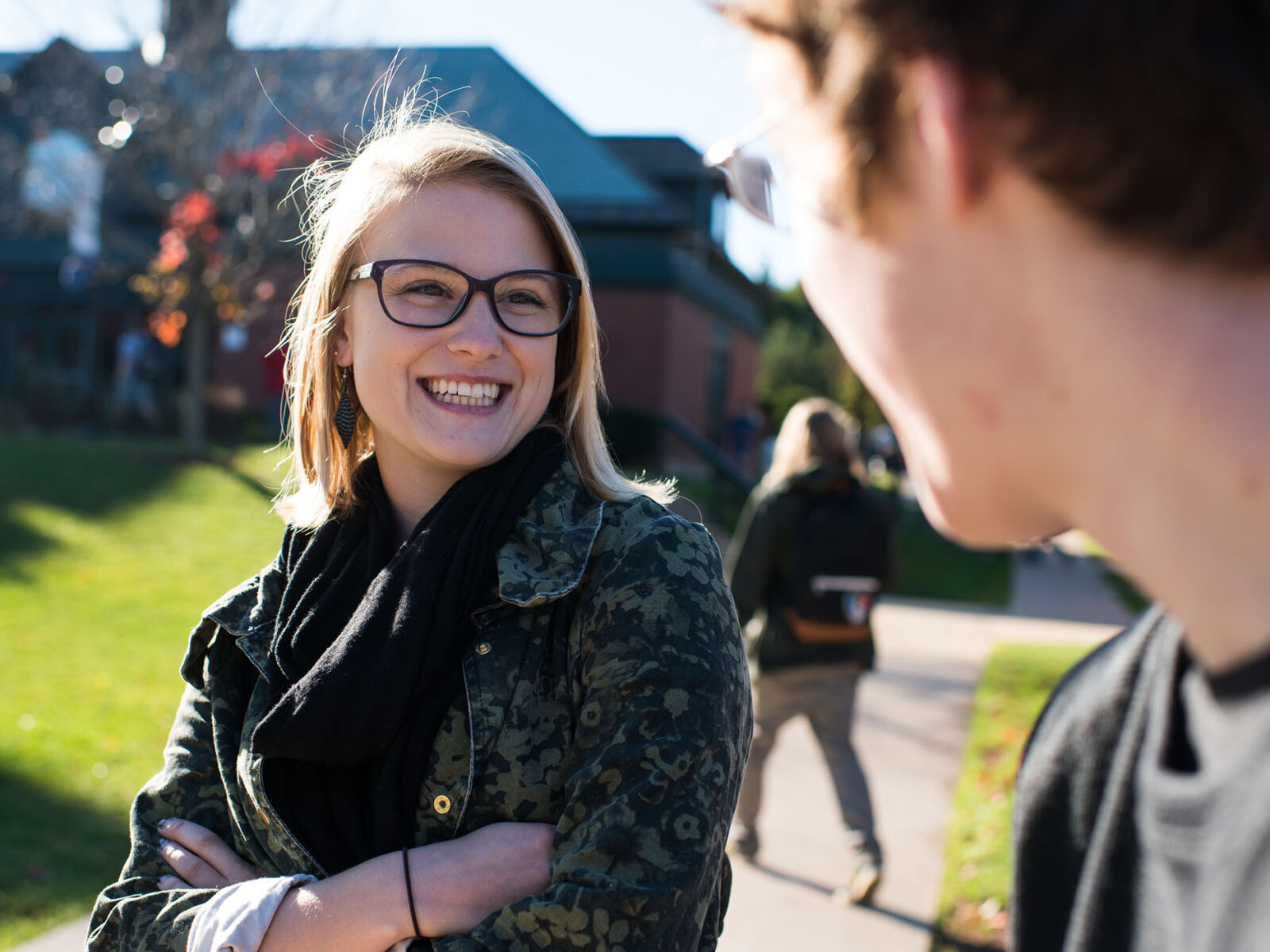 a champlain college student smiles at another student