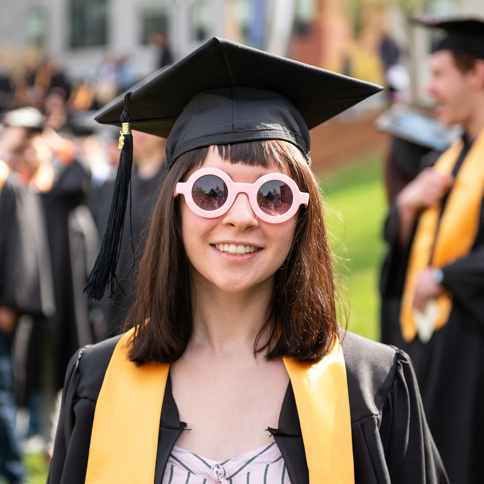 graduate wears fun sunglasses