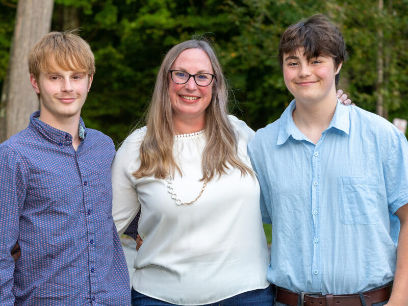 mom with teenage sons on either side