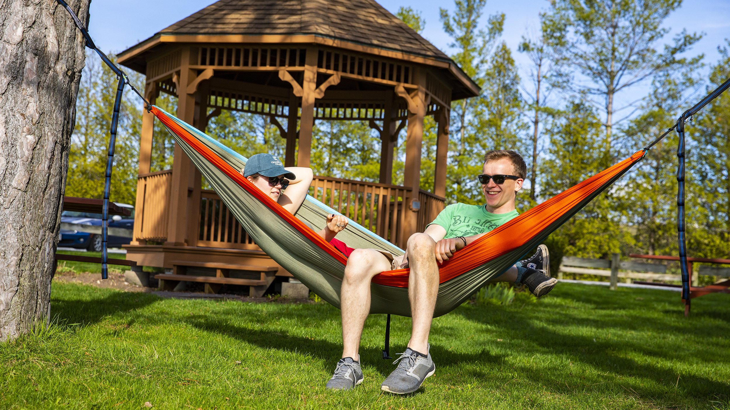 two student enjoy a sunny day in a hammock