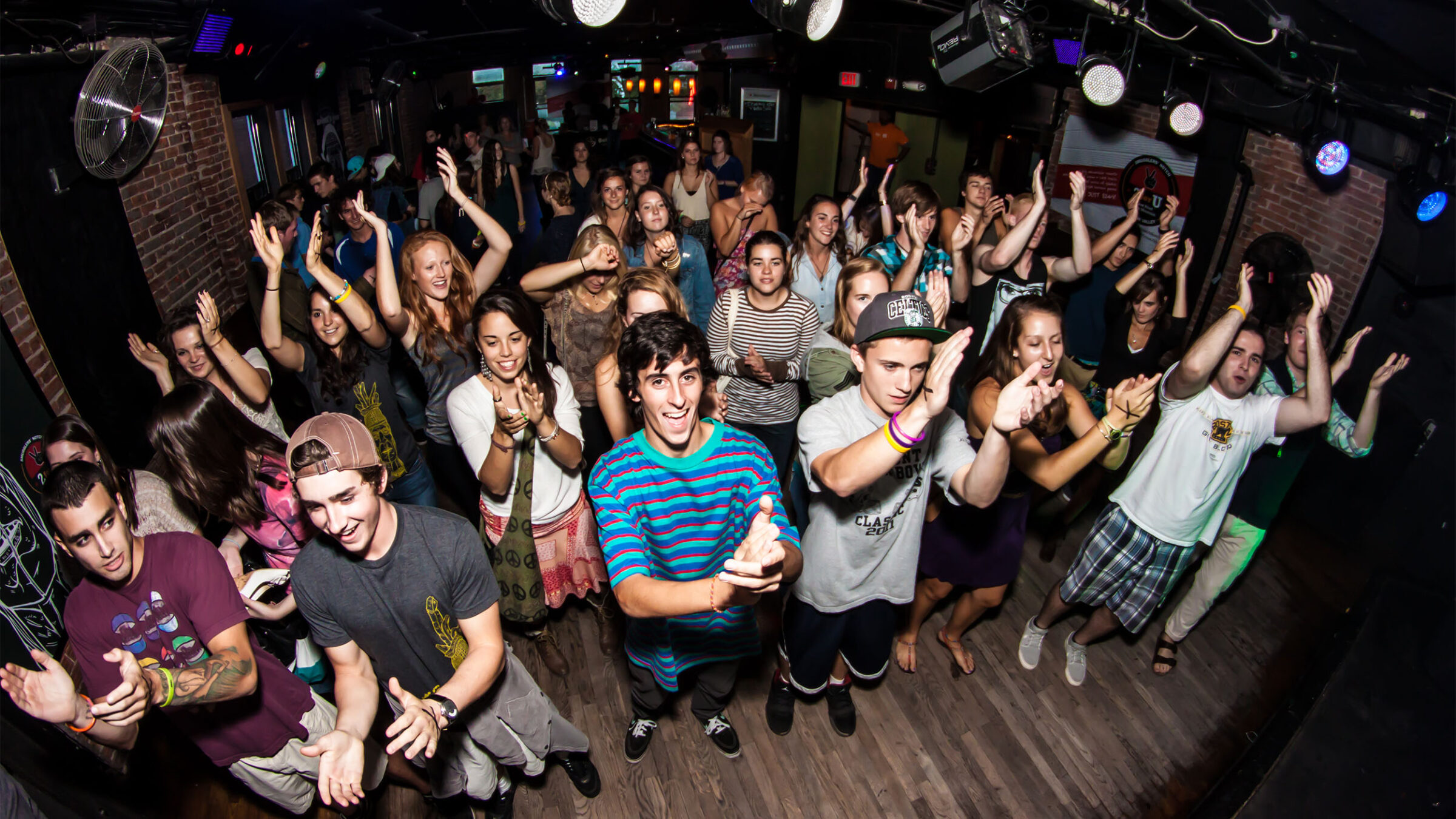 group of students clapping in a club-like environment