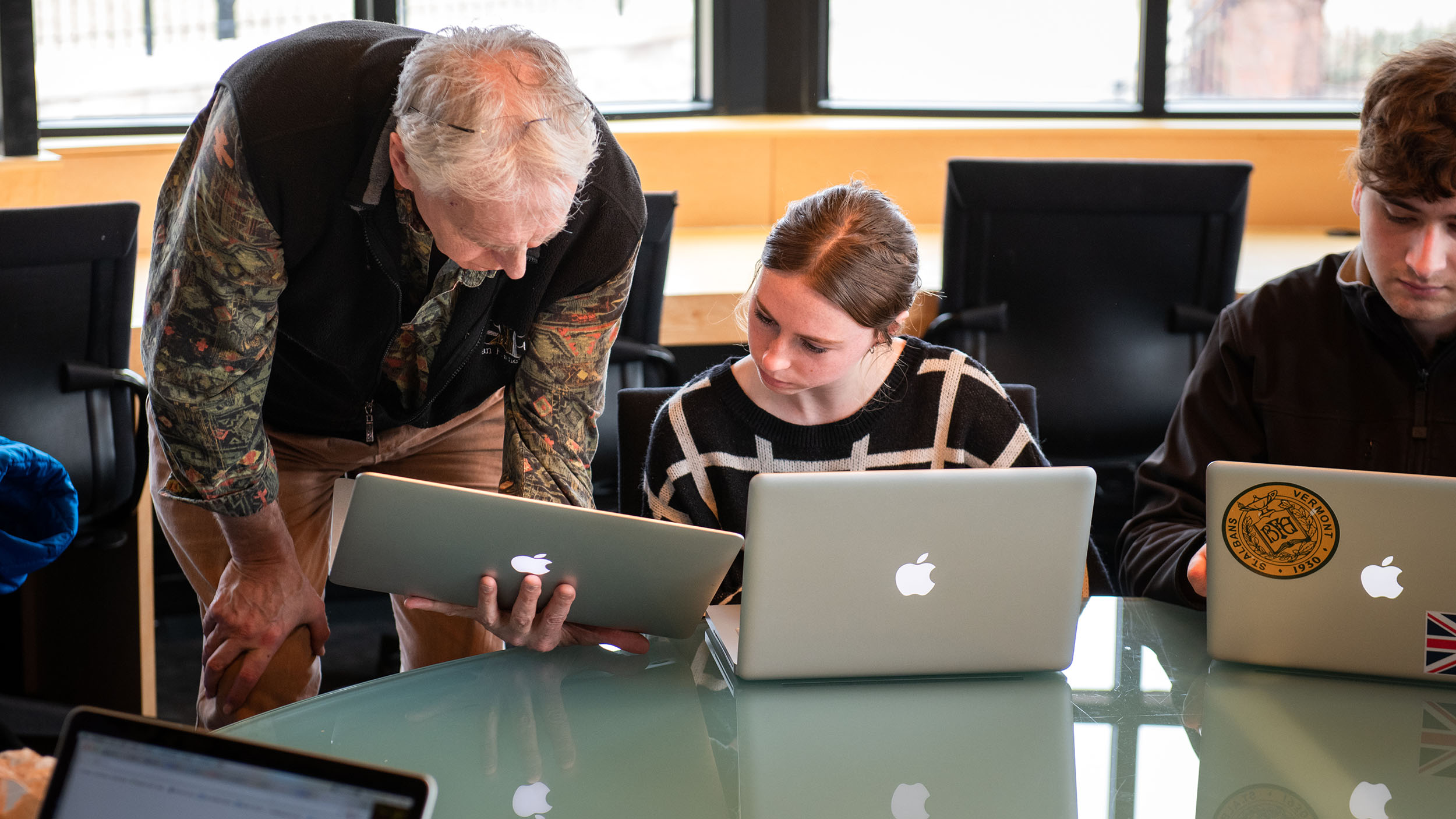 stiller school of business professor sharing something on his laptop with a student