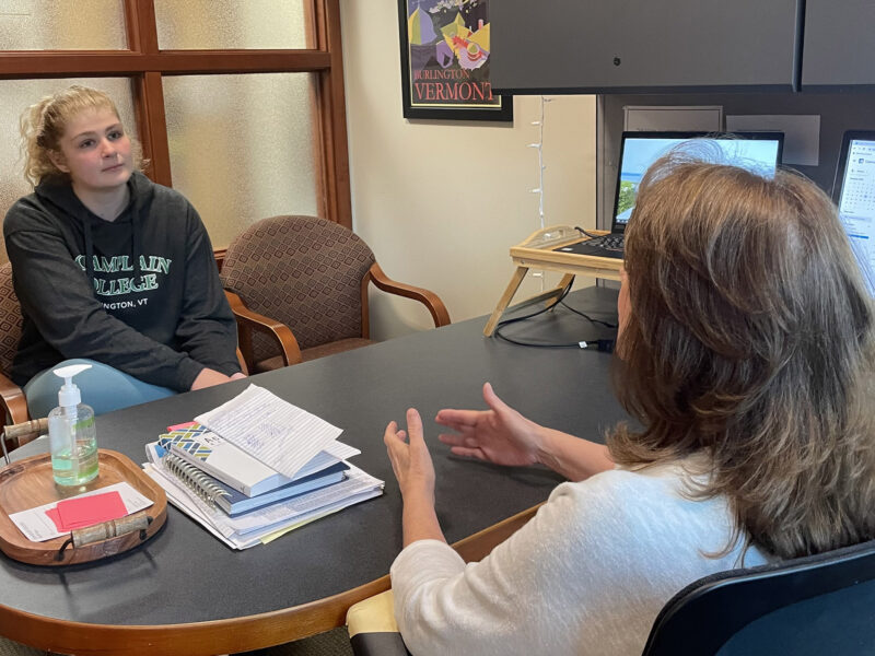 academic coach talks to student in an office