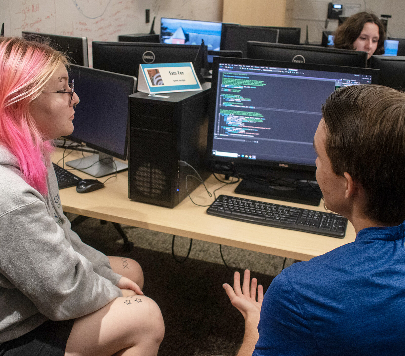 students talk about computer programming in the tutoring center