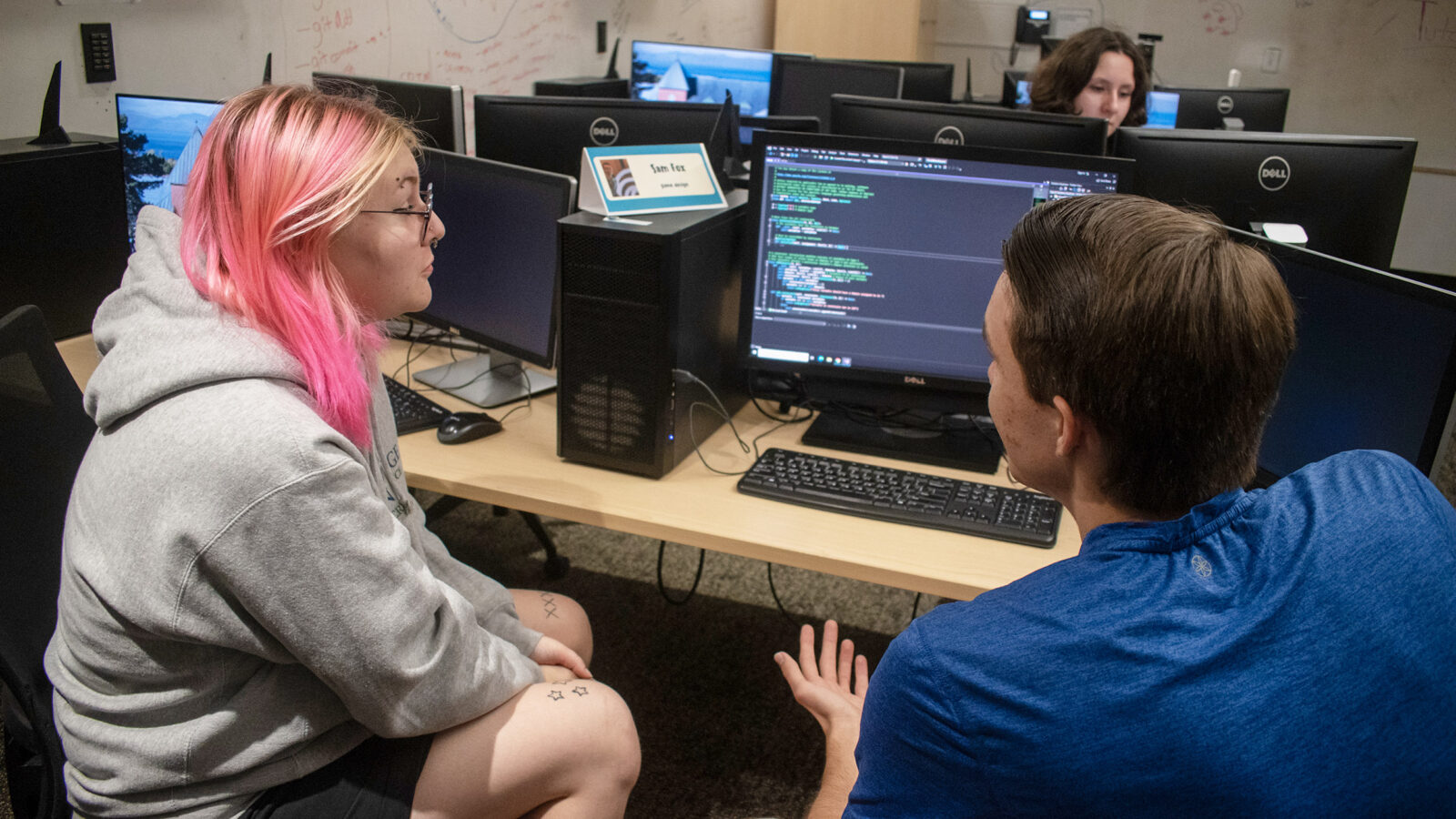 students talk about computer programming in the tutoring center