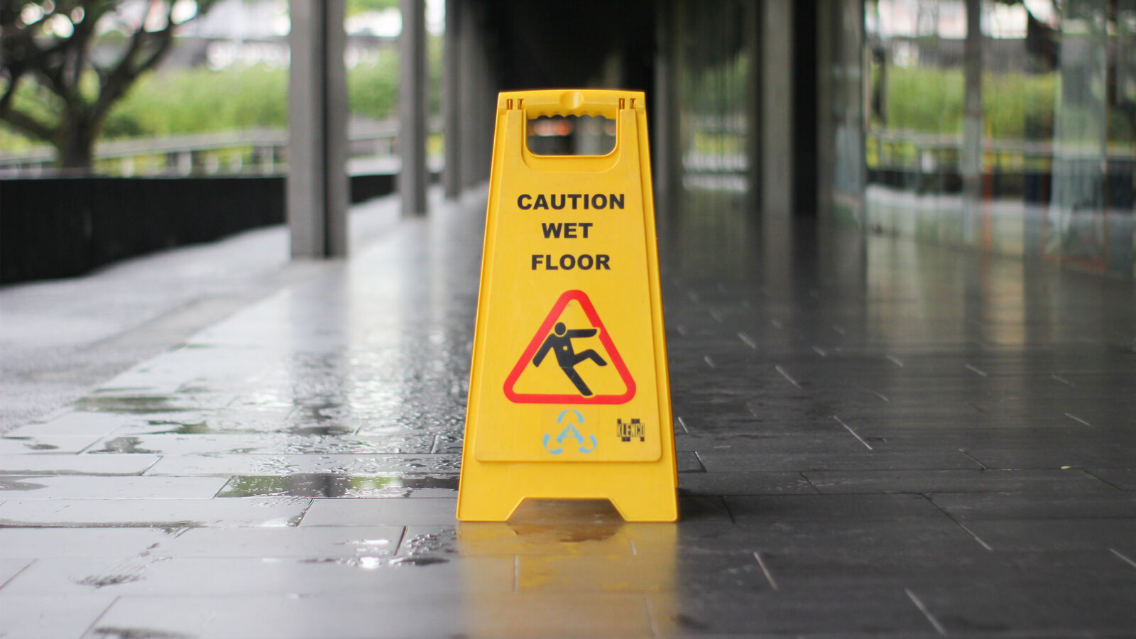 a wet floor sign on an outdoor walkway