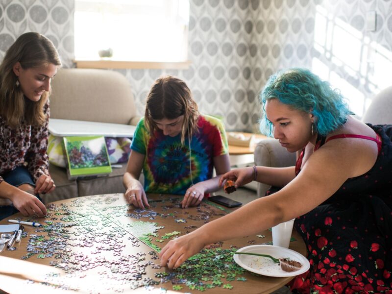 Students in the WGC completing a puzzle with sunlight shining through the window