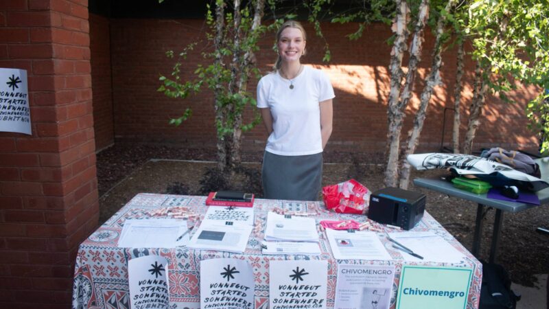 Student standing behind Chivomengro club table outside