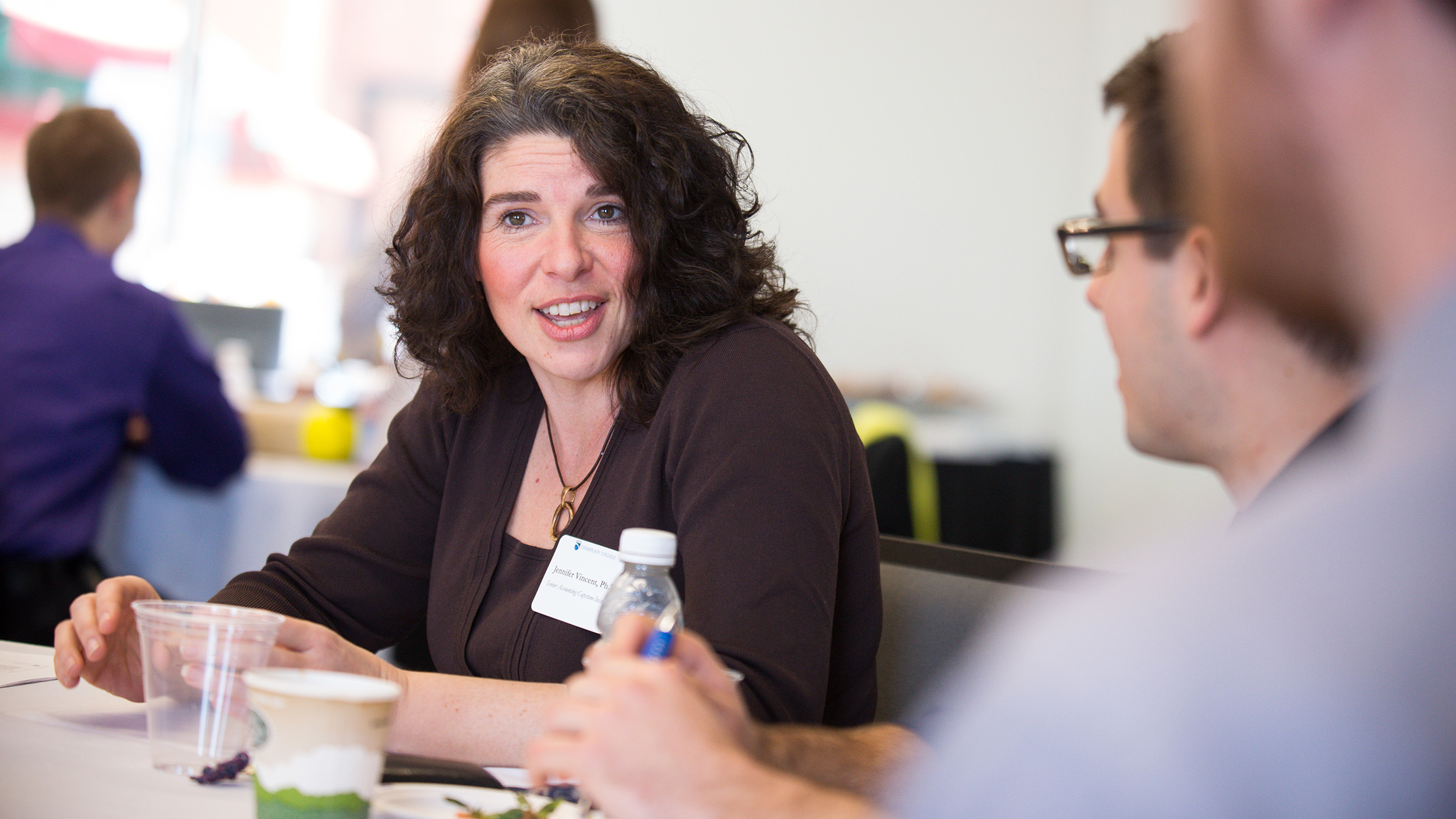 mom, dad, young adult child sitting together, smiling