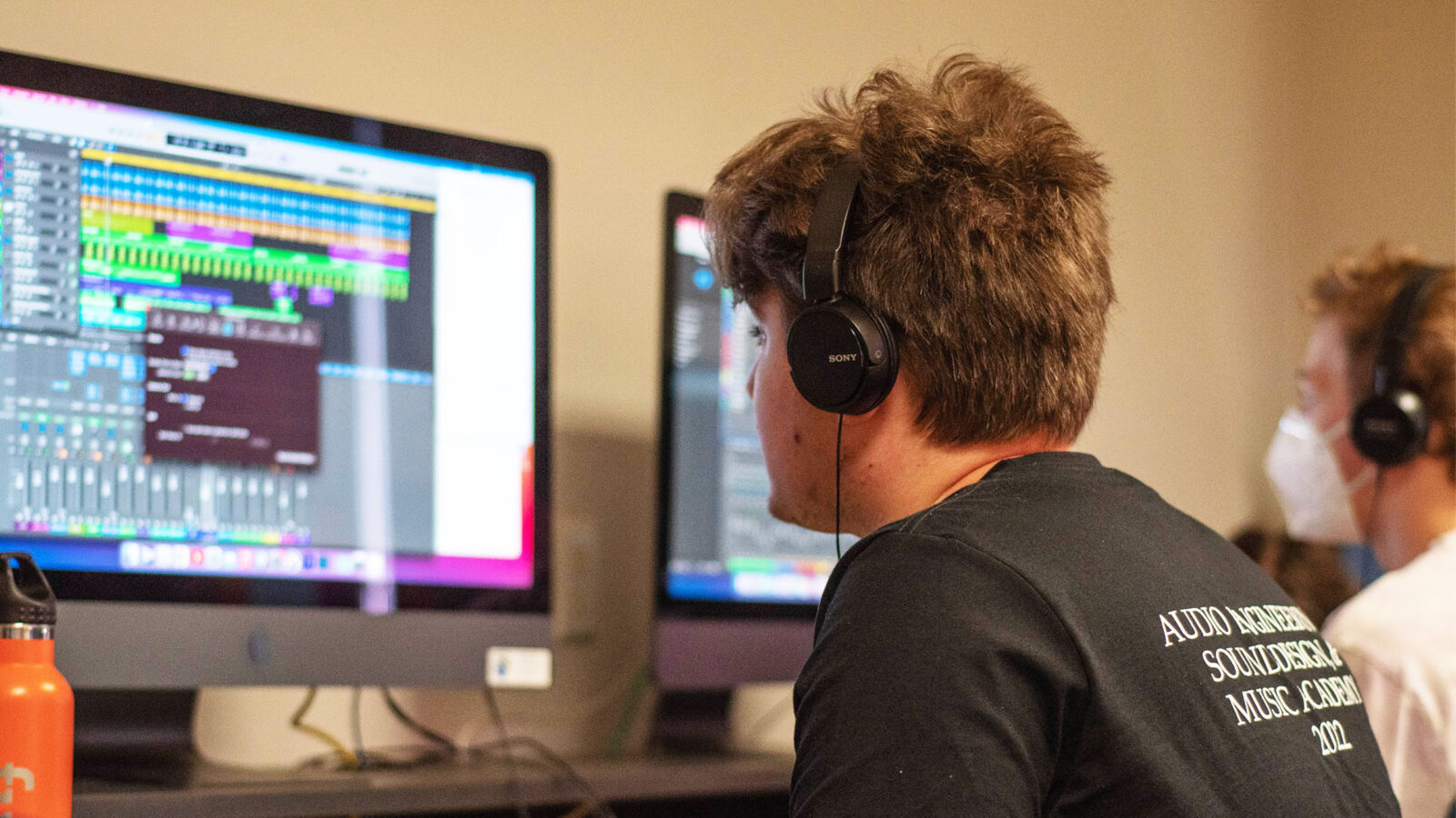 An audio student working on a project on their computer