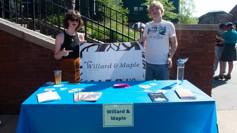Willard & Maple's student publication tabling at the activity fair with their logo