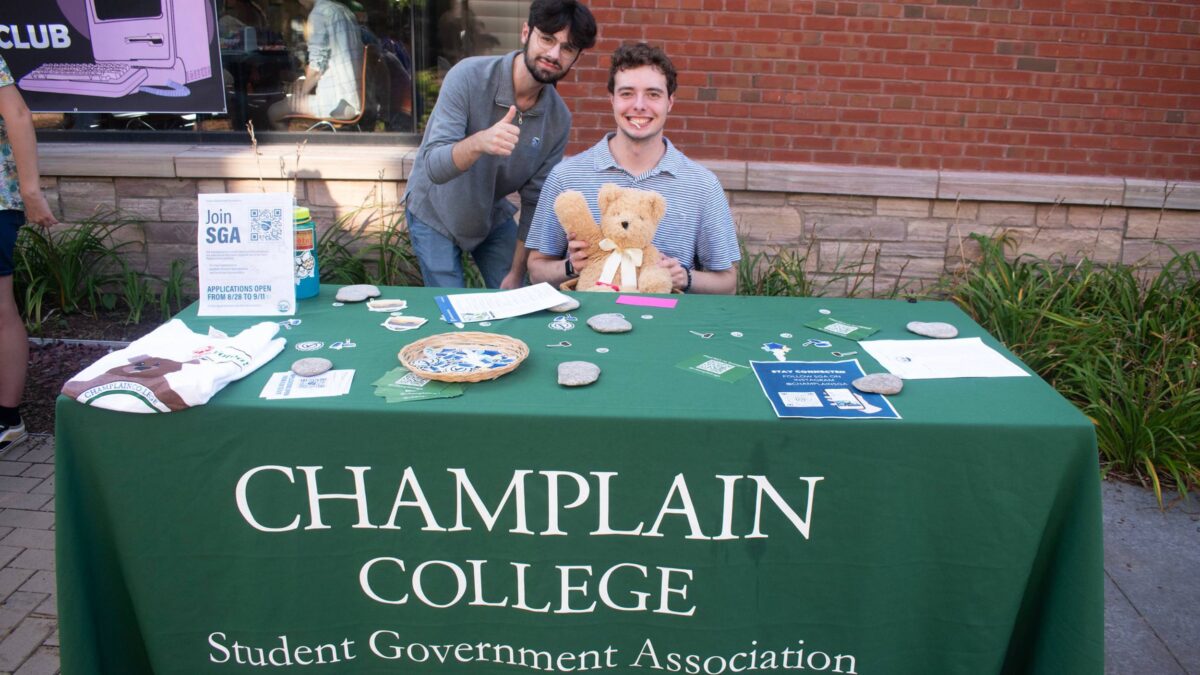 Student Government Associations activity fair table with two students smiling for the photo
