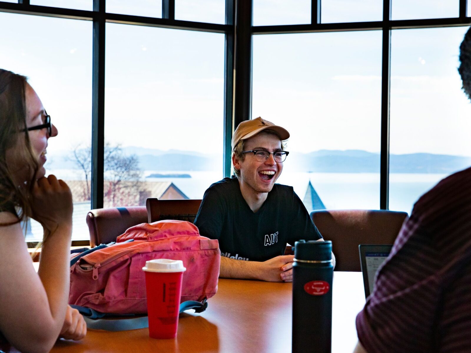 Students laughing in the vista room of the library on campus