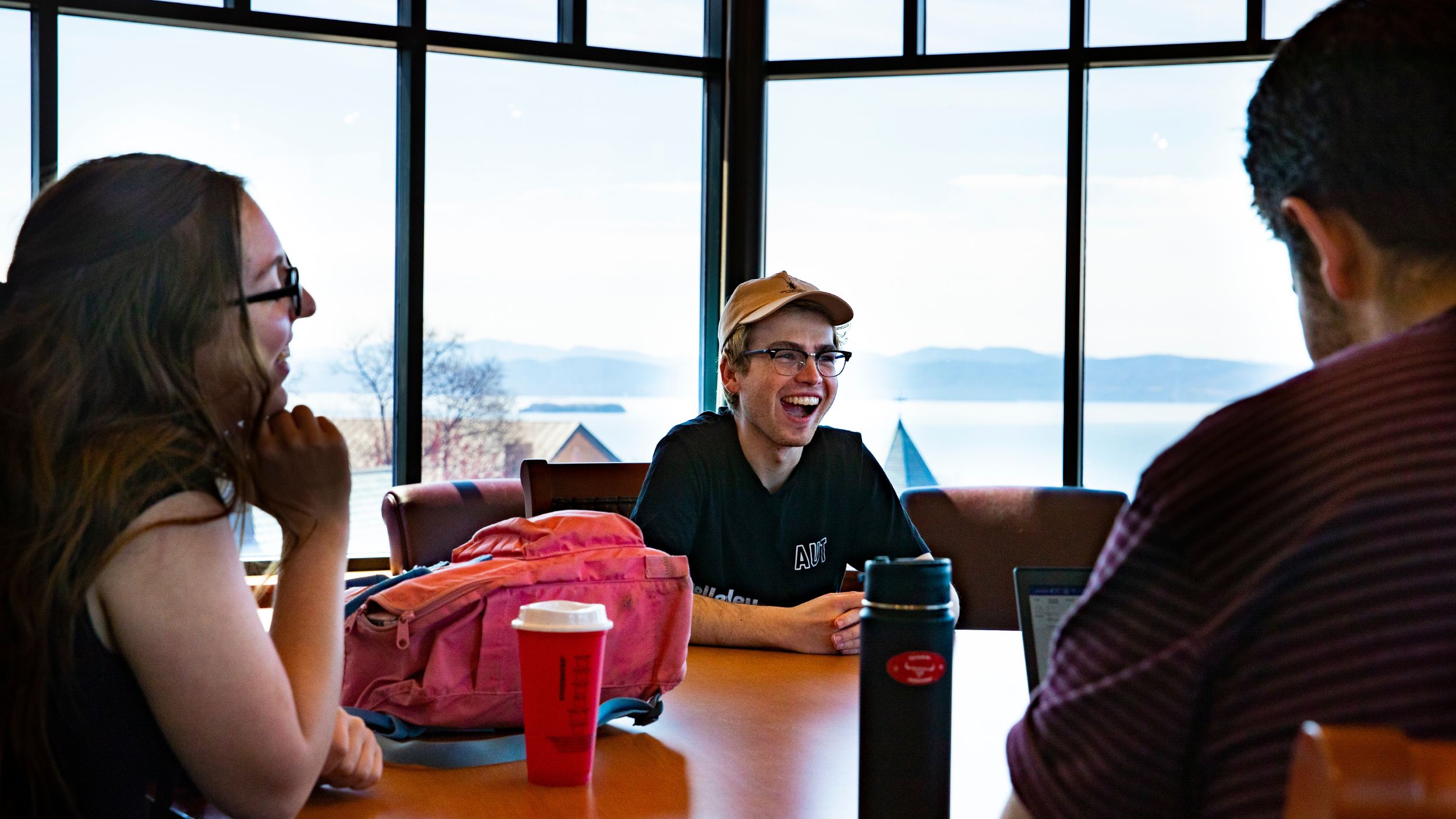 Students laughing in the vista room of the library on campus