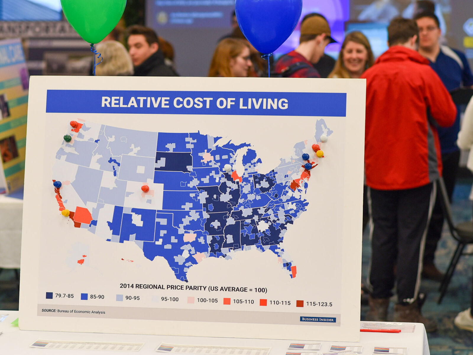 a poster with a map of the US showing cost of living in different areas